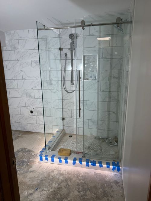 After — frameless glass shower in the remodeled basement bathroom — Manzil