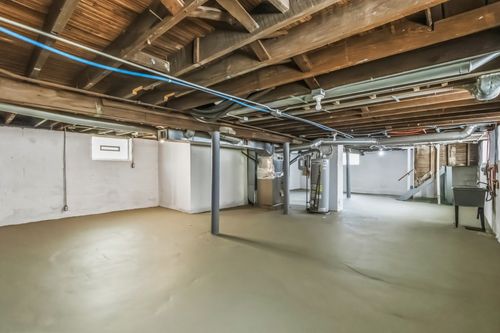 Before — exposed floor joists and subfloor during renovation — Manzil