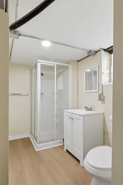 Before — room stripped to framing before renovation — Manzil