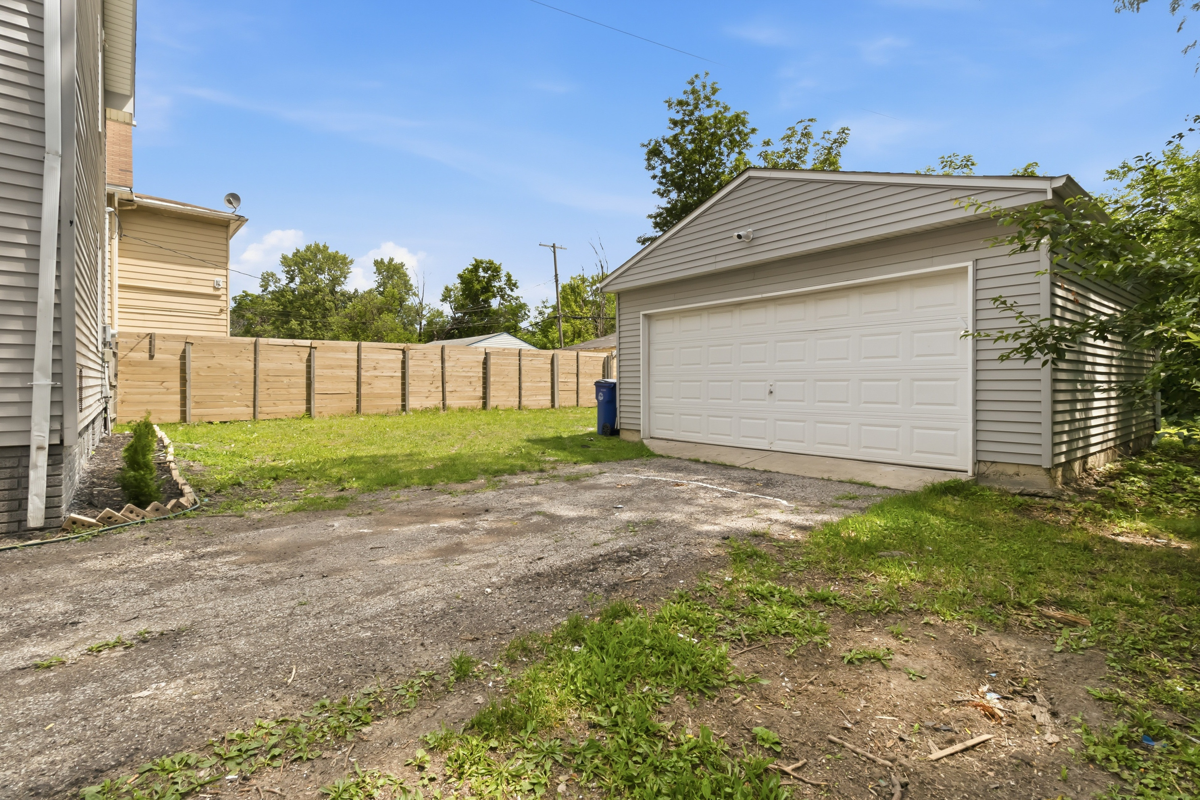 After — finished yard and detached garage after renovation — Manzil