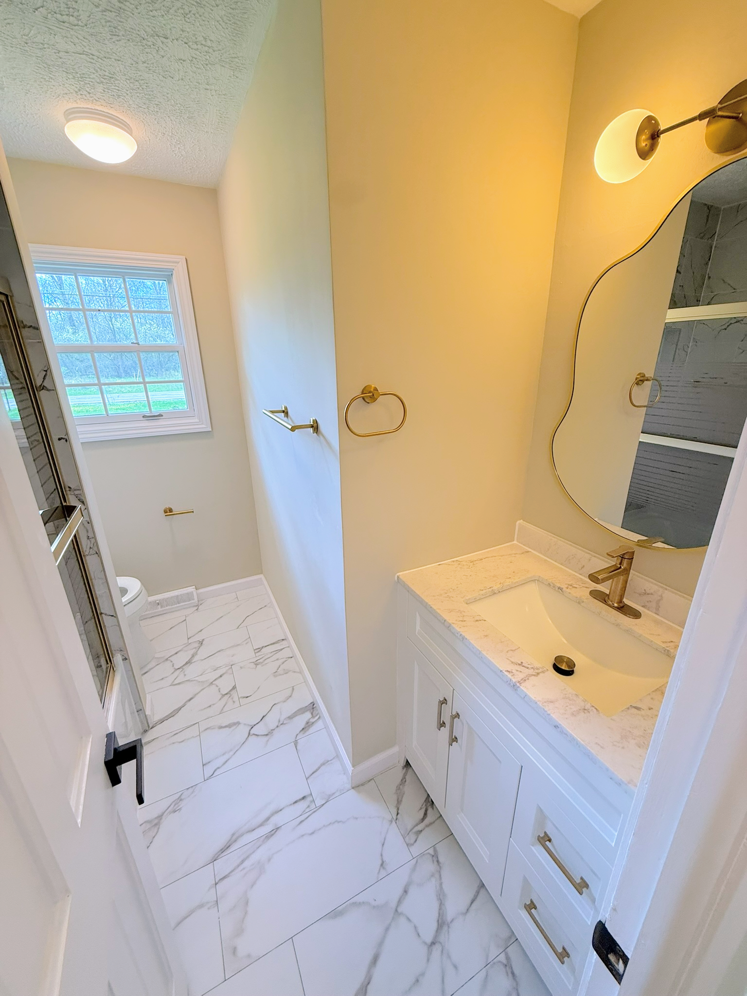 Walk-in glass shower and modern fixtures in a renovated Cleveland bathroom