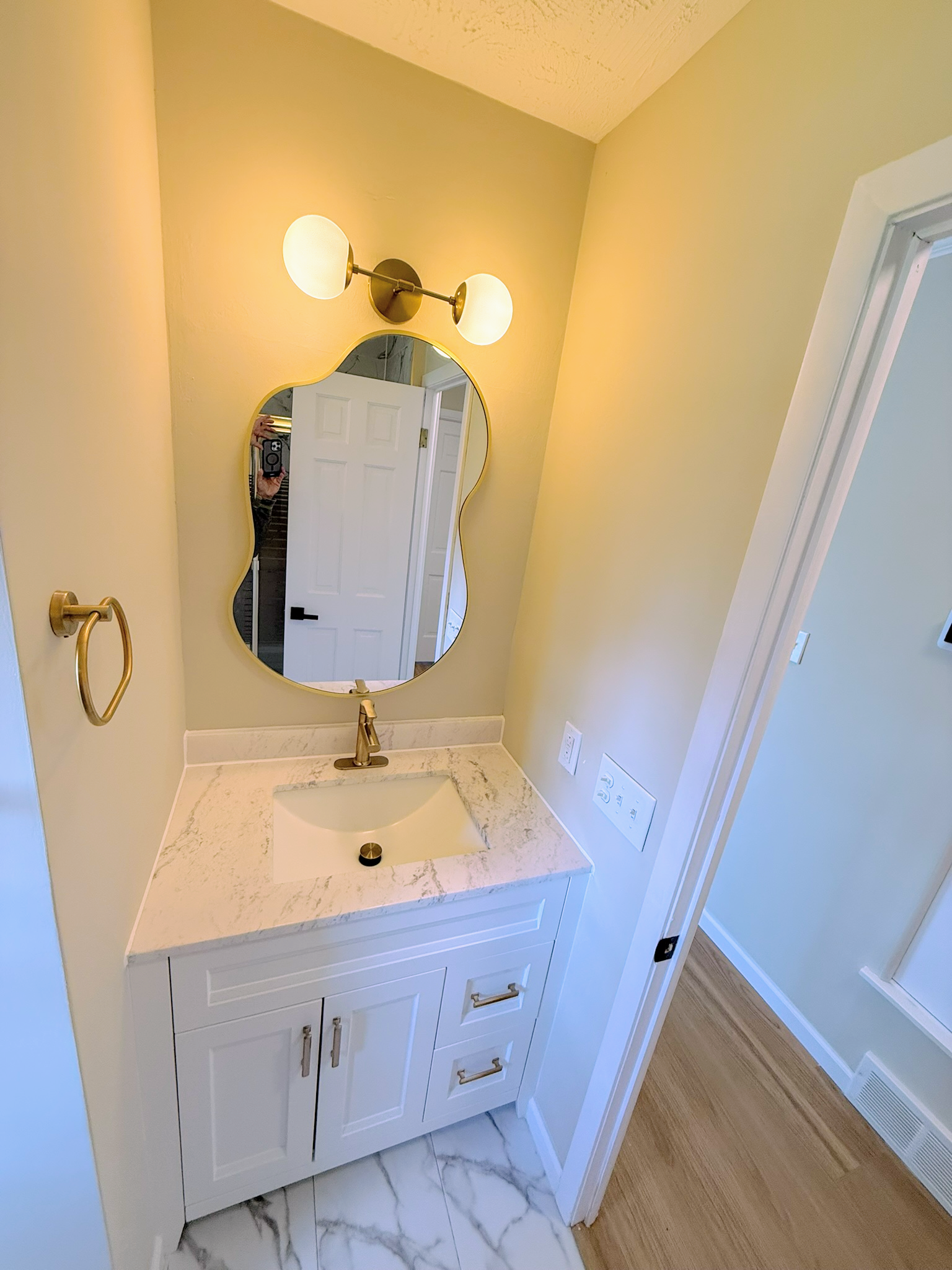 Second remodeled bathroom with a floor-to-ceiling tiled tub surround