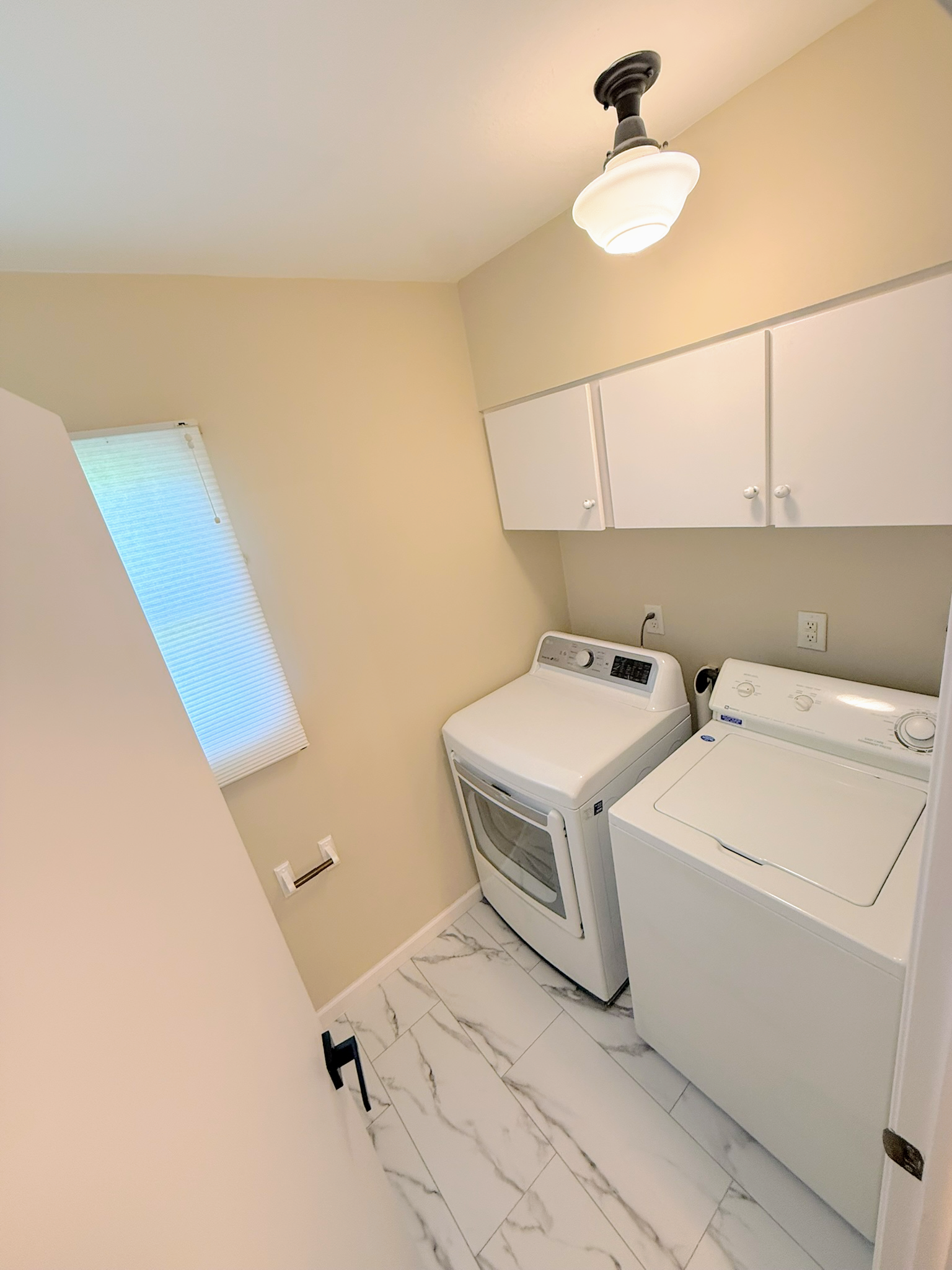 Refreshed bedroom with new flooring, paint and lighting in a Cleveland ranch