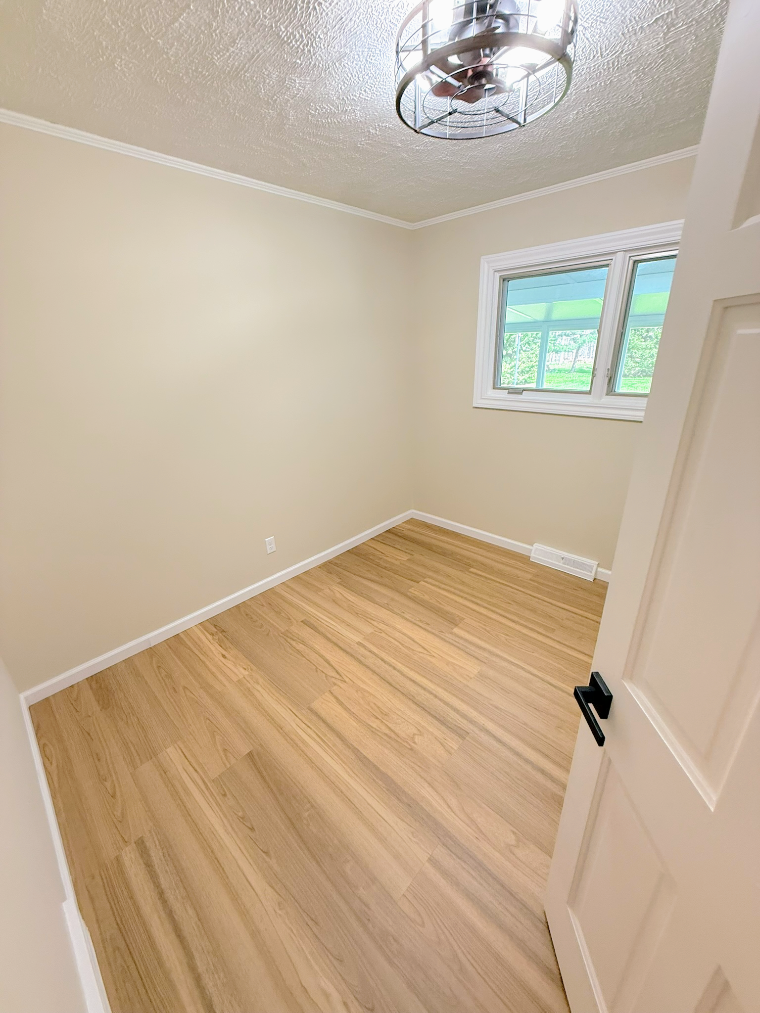 Renovated laundry room with new cabinetry and durable flooring