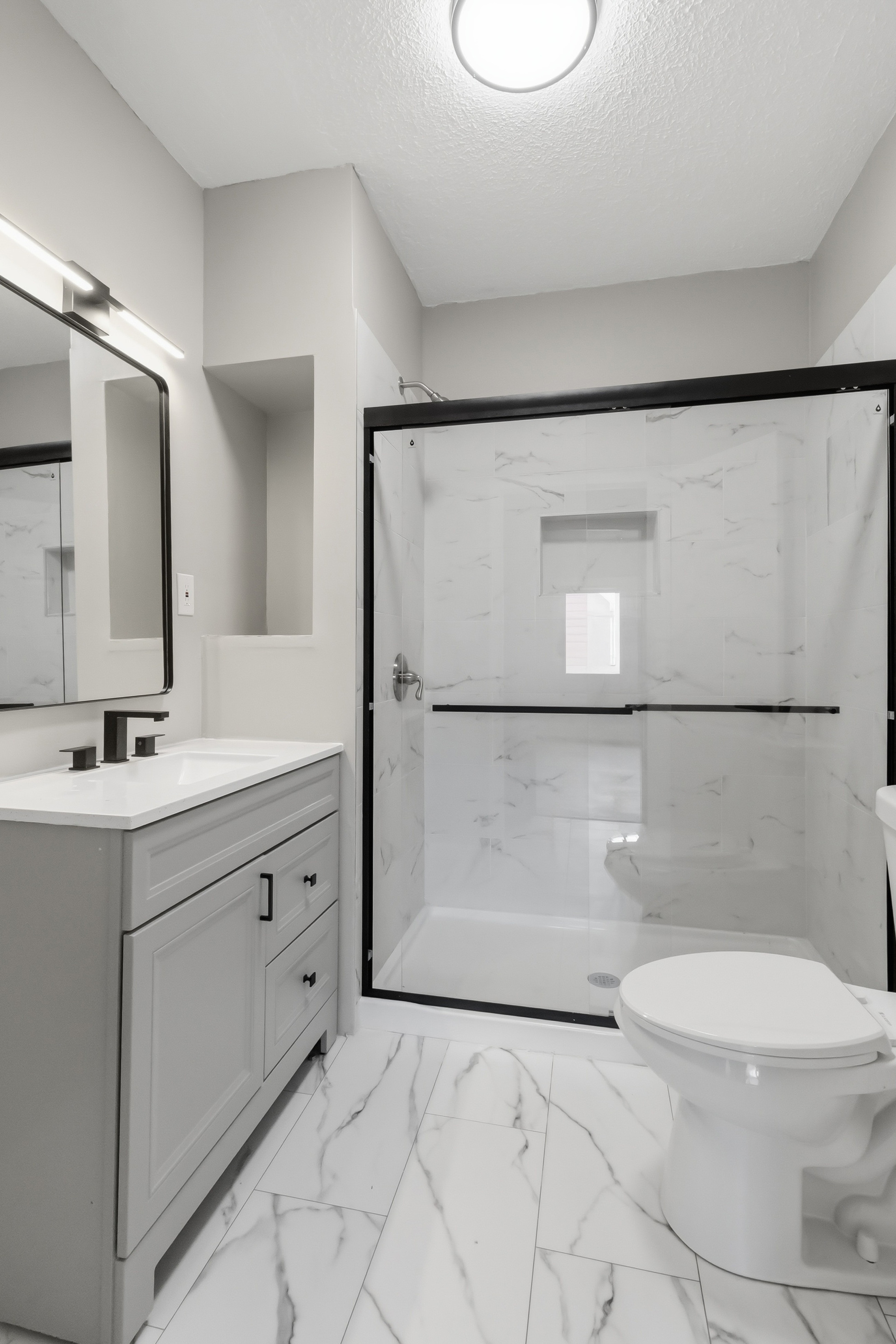 After — remodeled bathroom after full renovation — Manzil Renovation