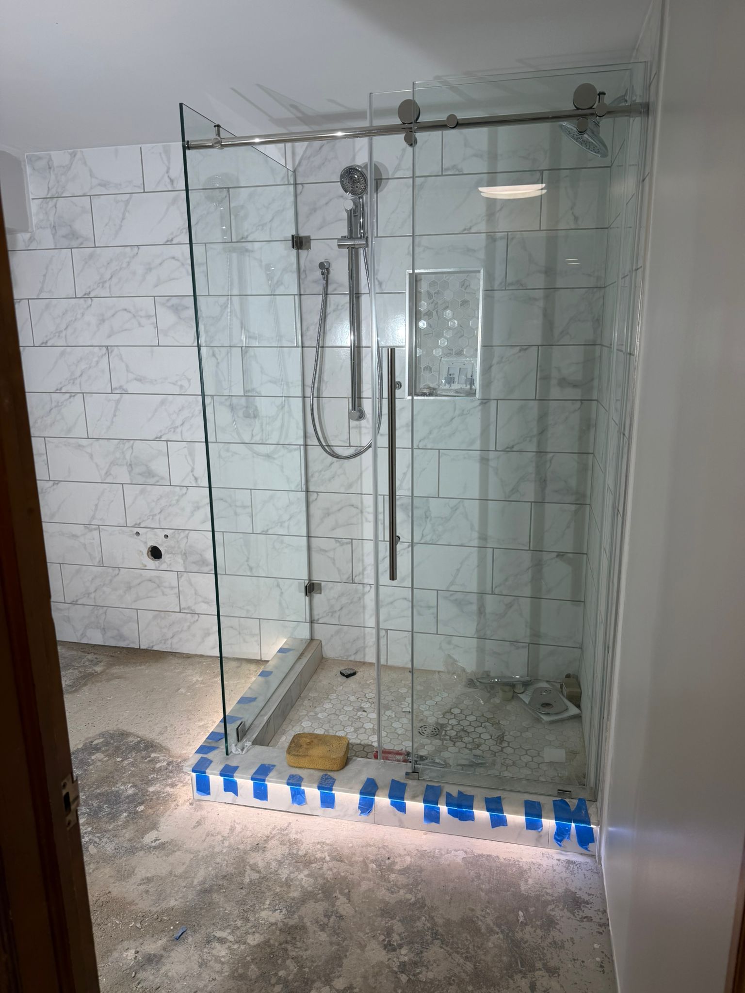 Frameless glass shower in a remodeled basement bathroom in Pepper Pike, OH