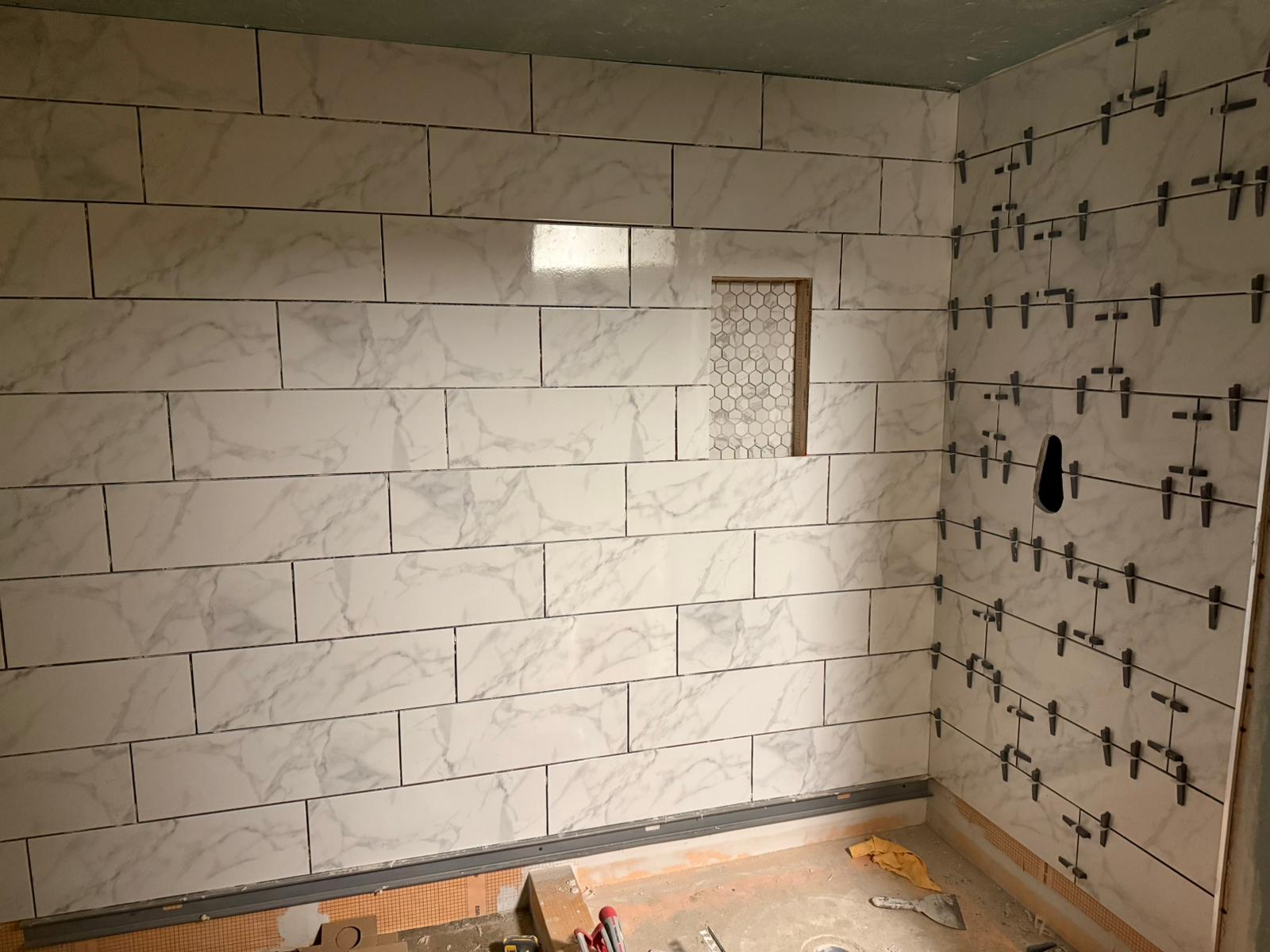 Before — exposed concrete block foundation wall in Pepper Pike, OH — Manzil Renovation