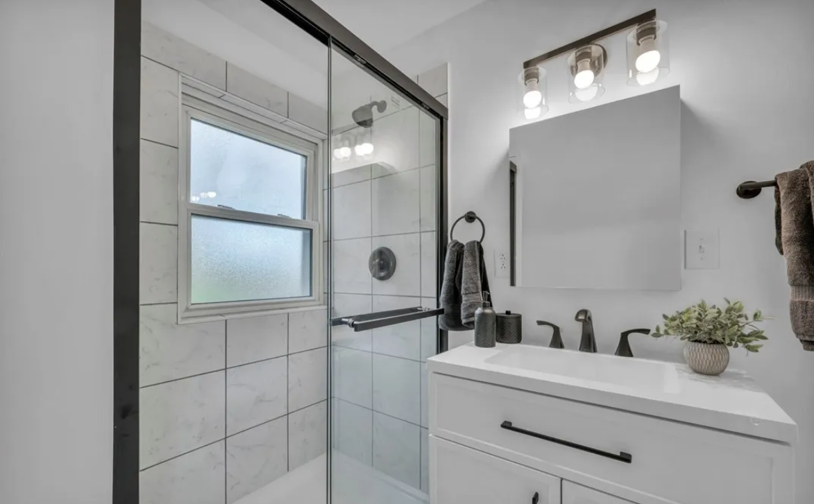 After — walk-in glass shower & double vanity in Brecksville, OH — Manzil Renovation