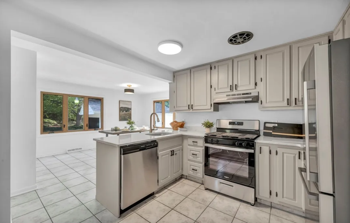 After — white shaker kitchen with quartz & stainless in Brecksville, OH — Manzil Renovation