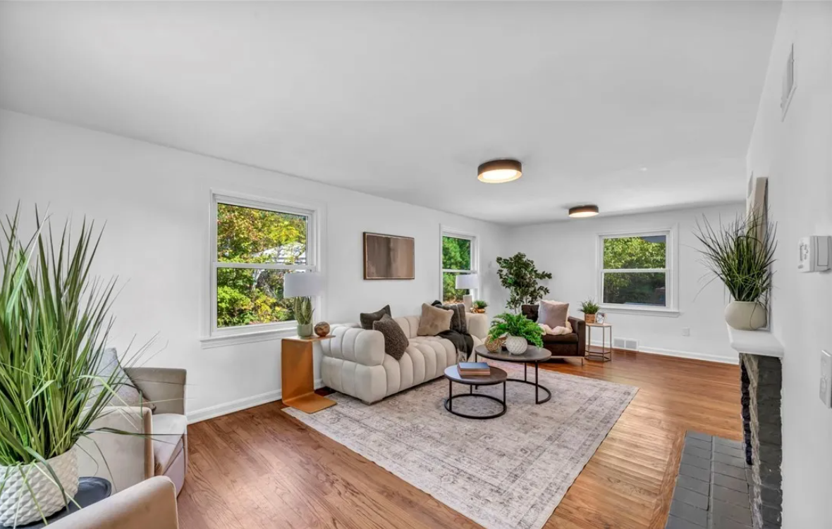 After — bright staged living room with refinished floors in Brecksville, OH — Manzil Renovation