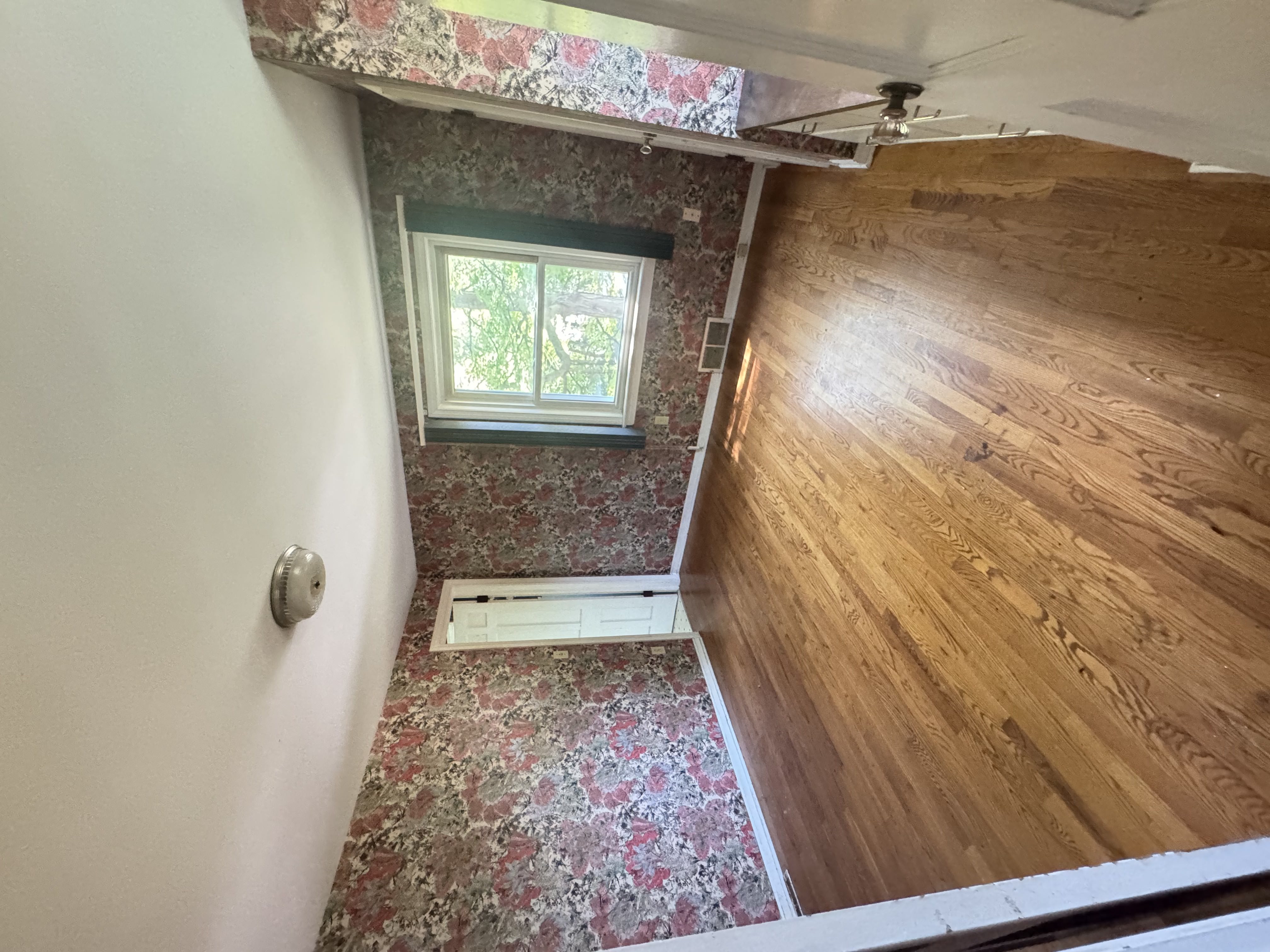 Before — bedroom with floral wallpaper in Brecksville, OH — Manzil Renovation