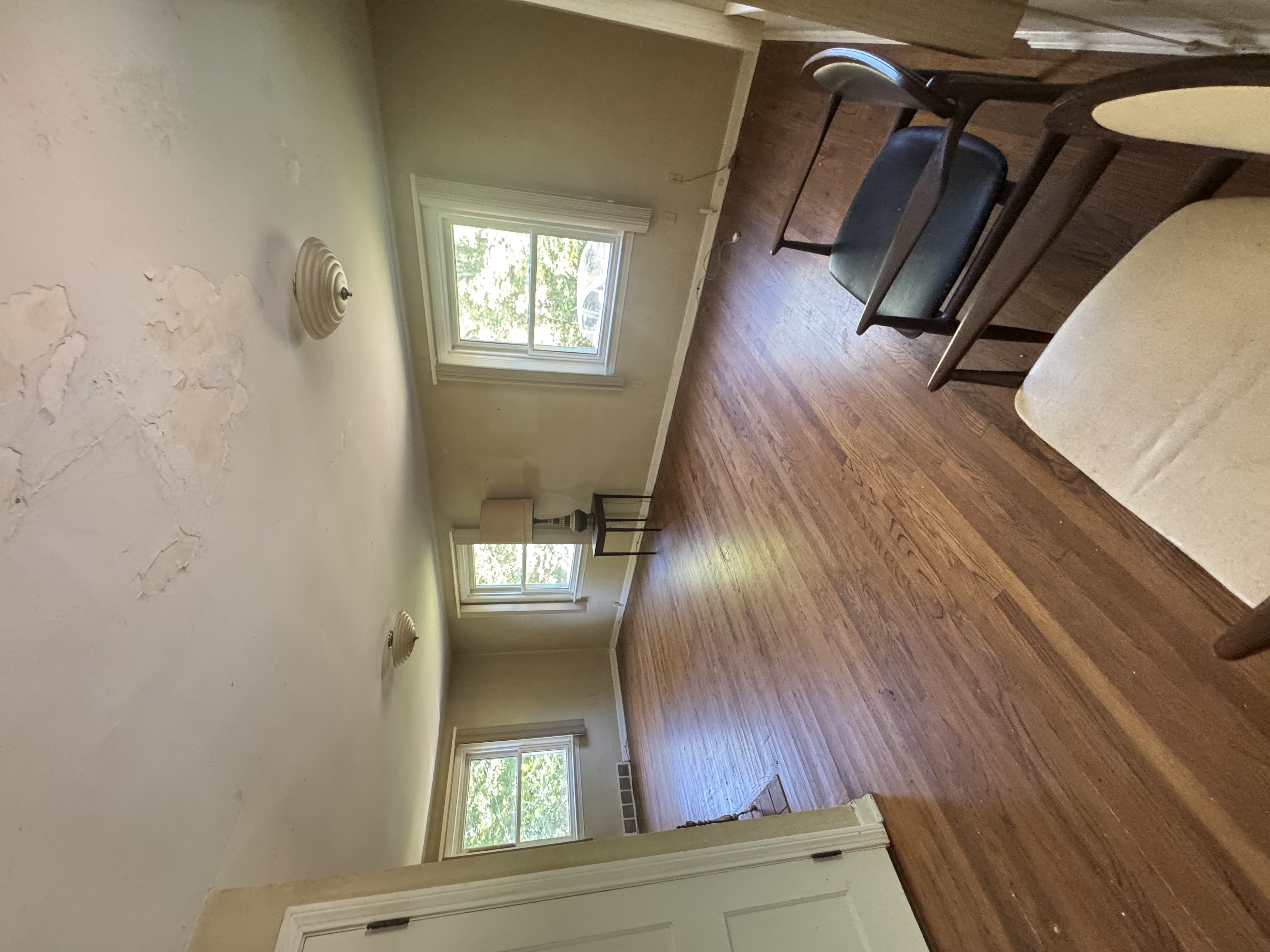Before — living room with tan walls and peeling ceiling in Brecksville, OH — Manzil Renovation