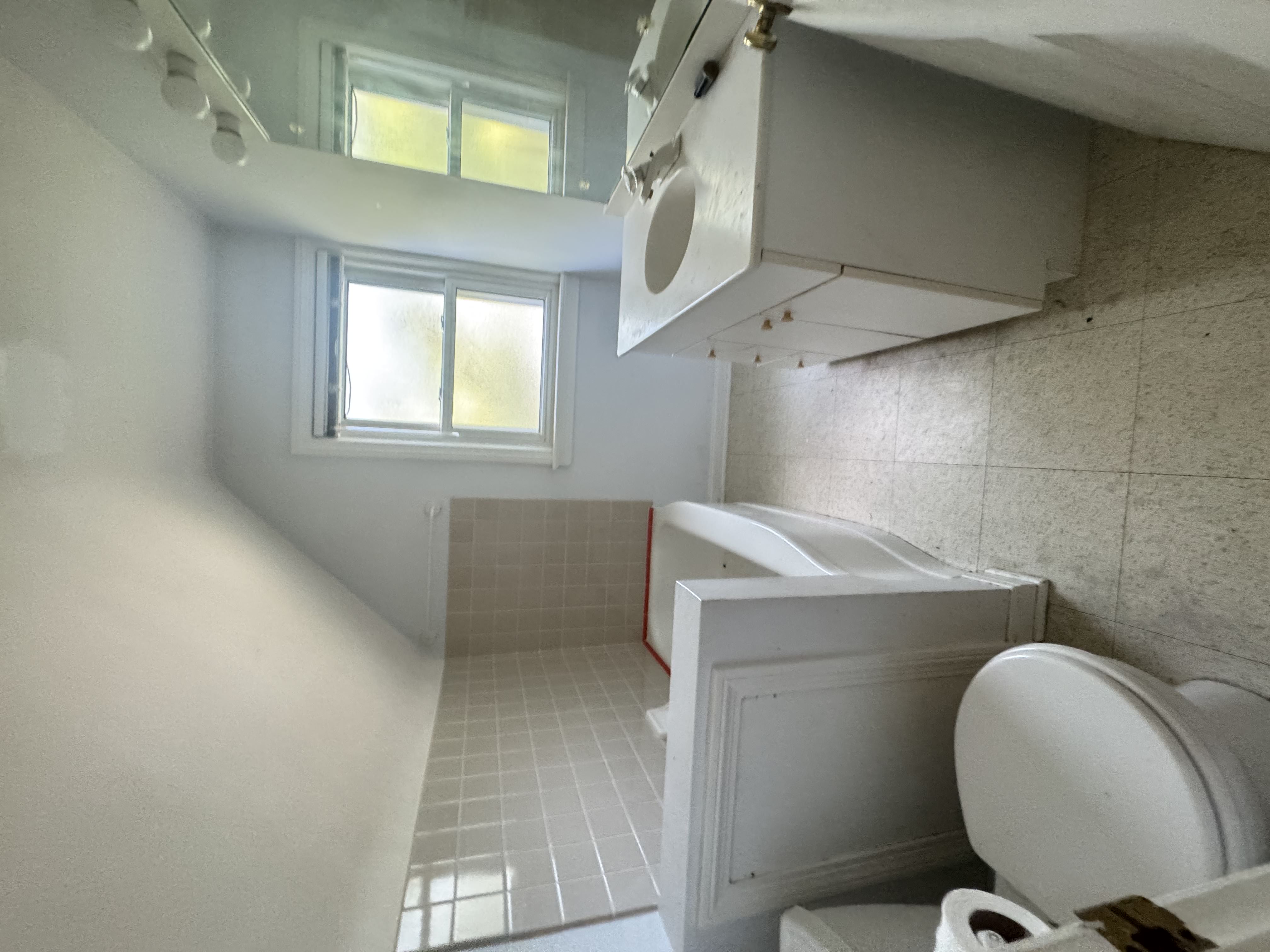Before — dated second bathroom with corner tub in Brecksville, OH — Manzil Renovation