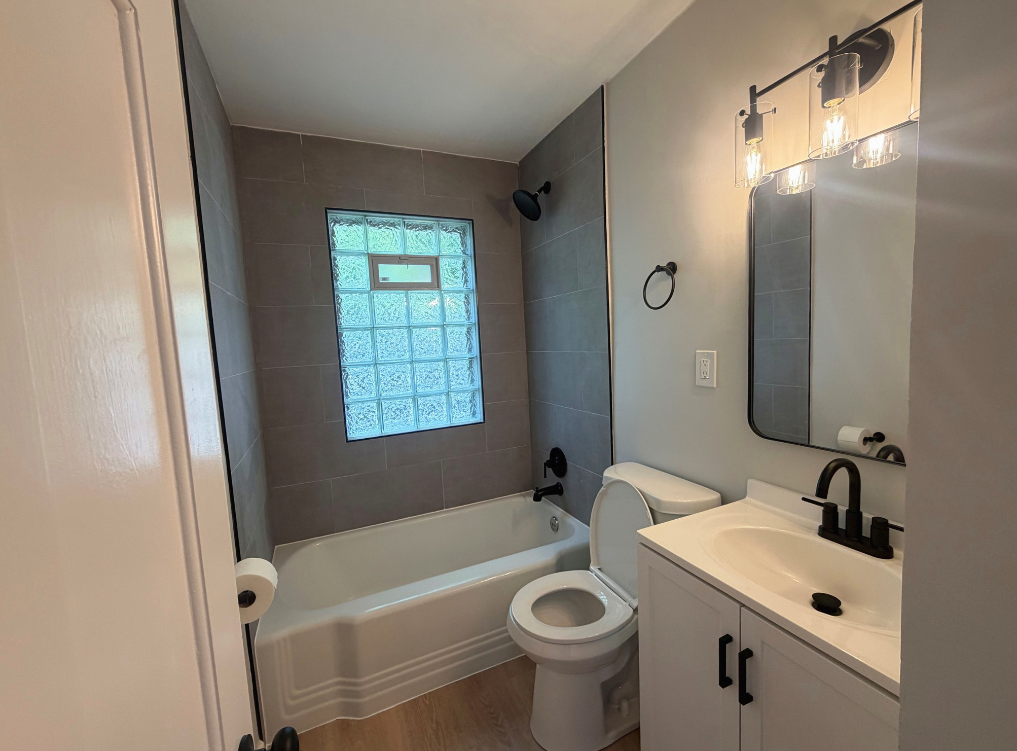 Remodeled bathroom with glass-block window, new tub and toilet, Wayland Ave Cleveland renovation