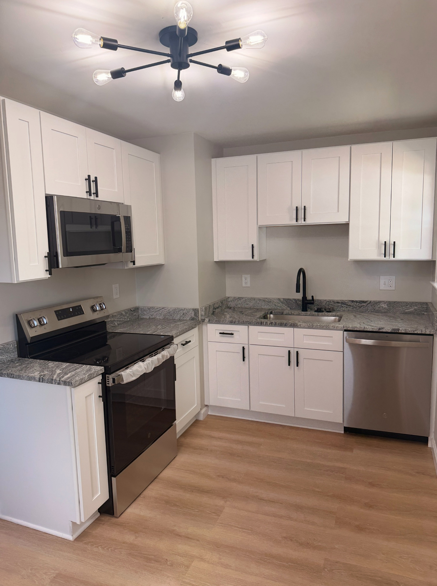 Close-up of new countertop and cabinet finishes in the kitchen, Wayland Ave Cleveland renovation