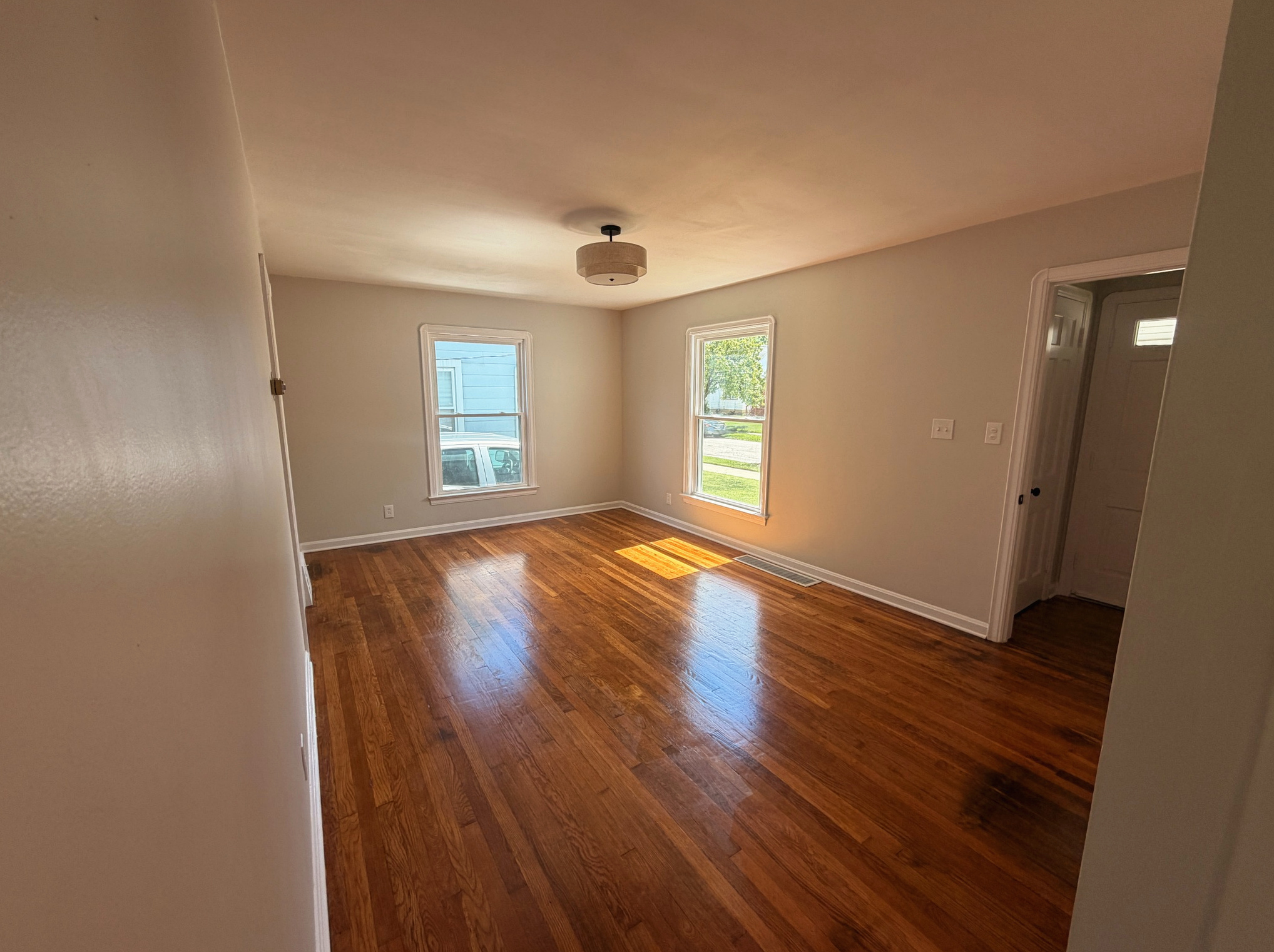 Living room with refinished hardwood floors, Wayland Ave Cleveland renovation