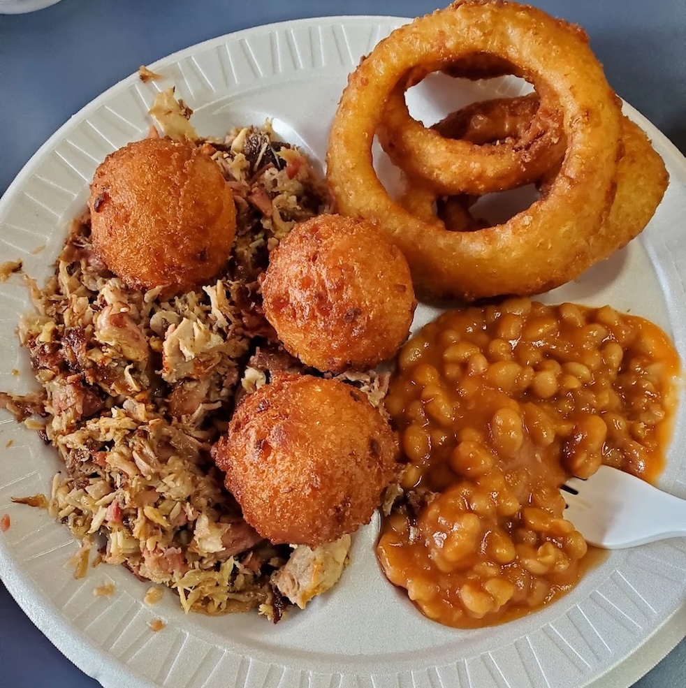 Hushpuppies, pulled pork, beans, and onion rings