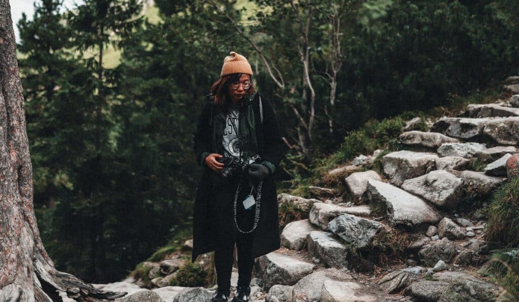 A hiker using a camera harness to keep their camera accessible.