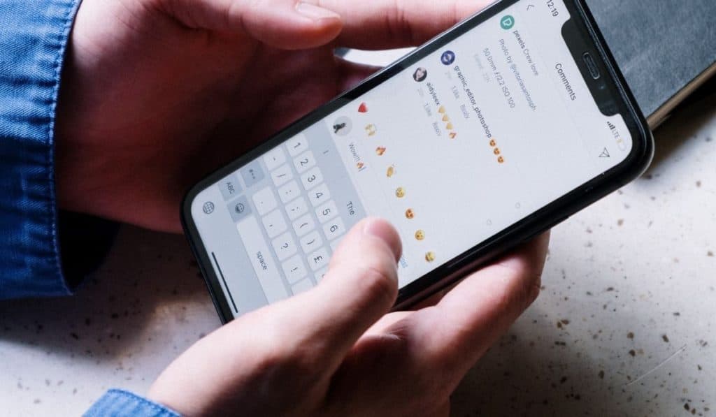 A person responding to comments on their phone, showing engagement with followers.