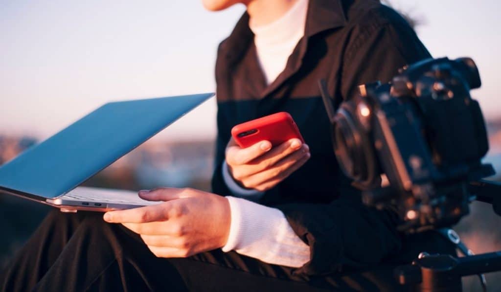 A person looking thoughtfully at their phone