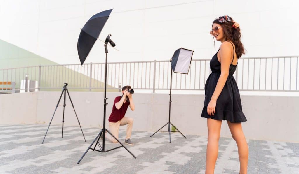 A photographer setting up a shot outdoors