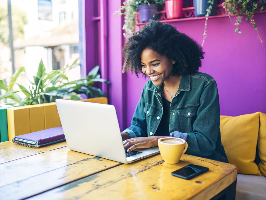 A young blogger working on a laptop in a vibrant coffee shop, embodying the essence of blogging.