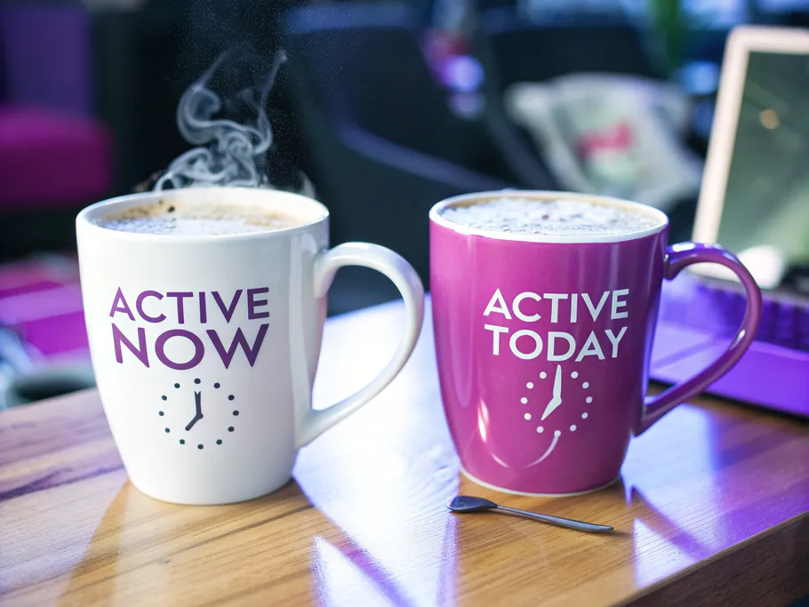 Two coffee cups representing Instagram's active status; one steaming with 'ACTIVE NOW' and one lukewarm with 'ACTIVE TODAY'.