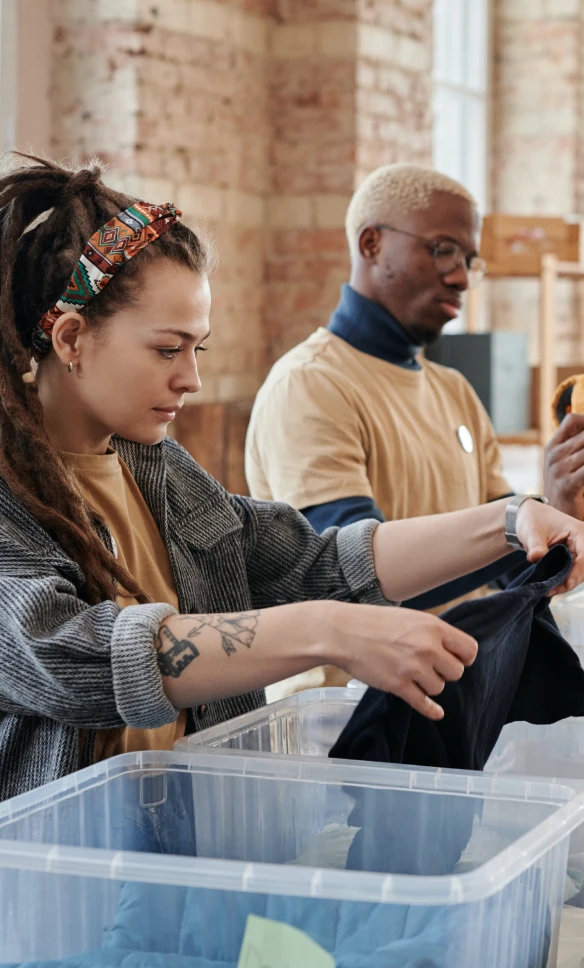 Woman folding clothes in bin