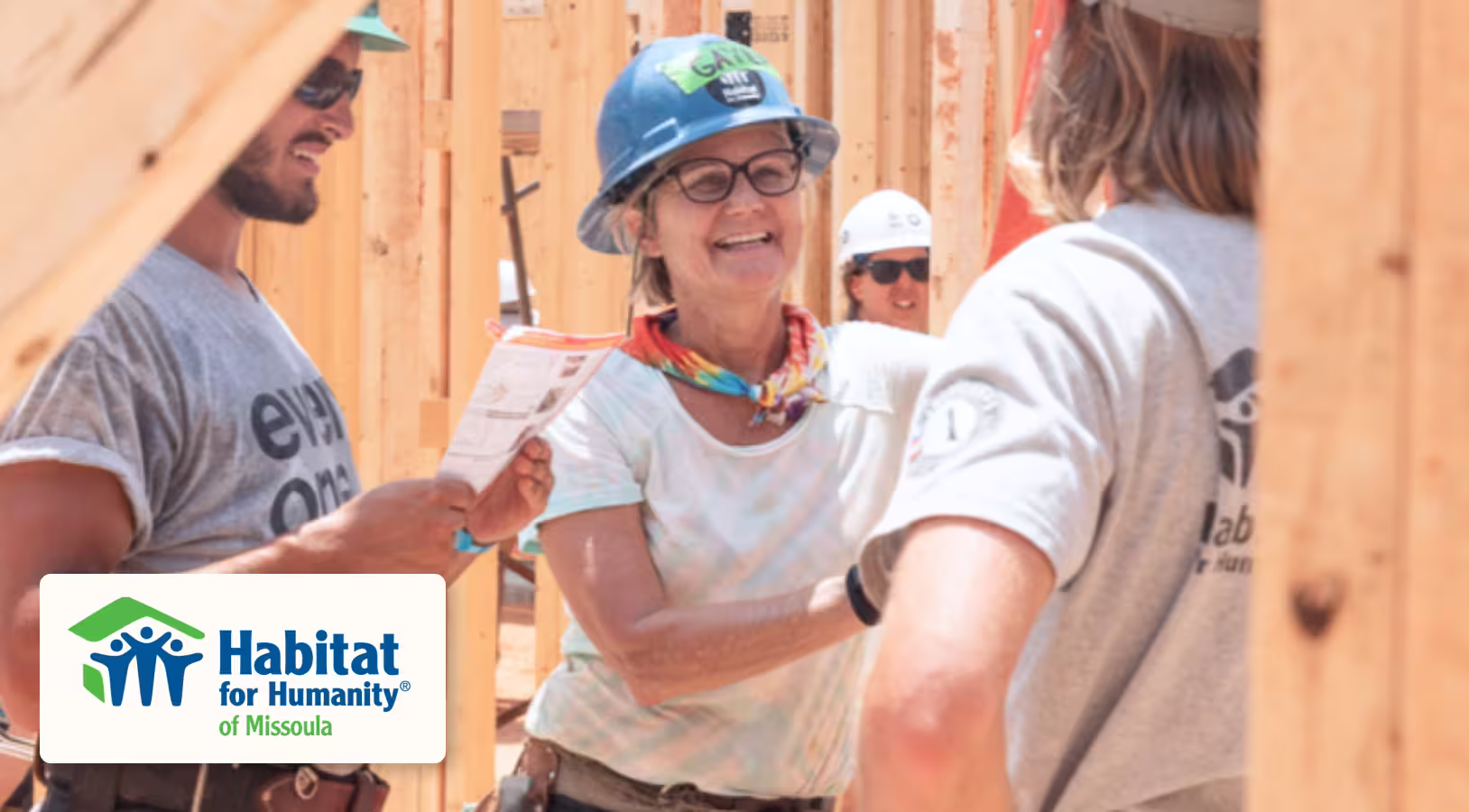 People in hard hats smiling working on constructions