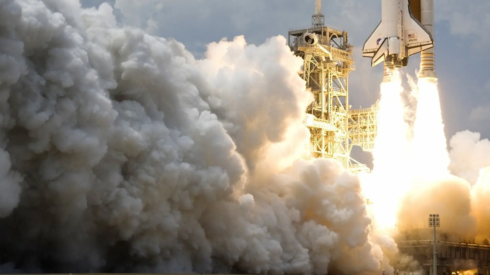 The space shuttle and launch rocket blasting off.