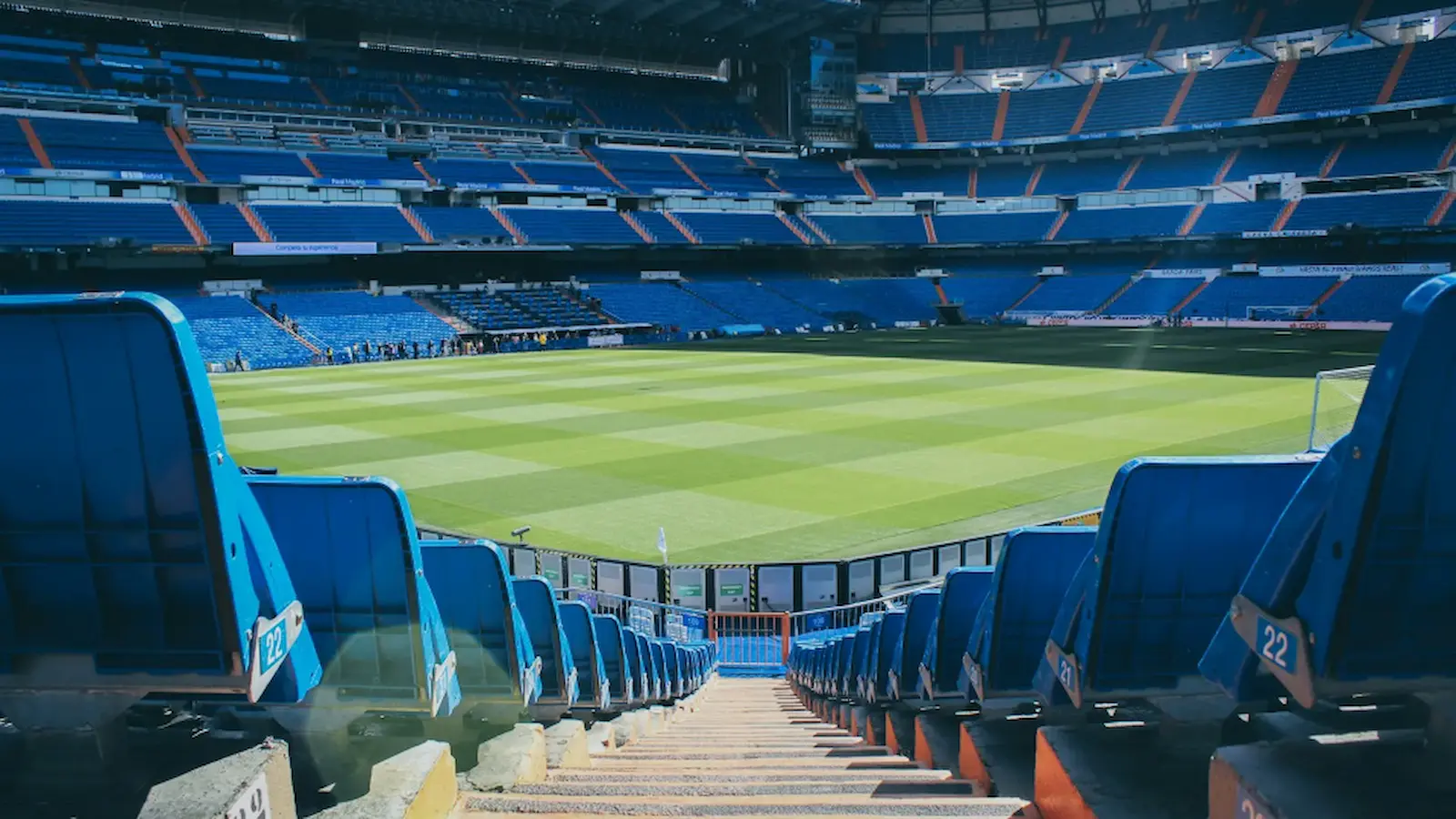 A view of a stadium's playing field from the seats on the bottom level of the stadium.