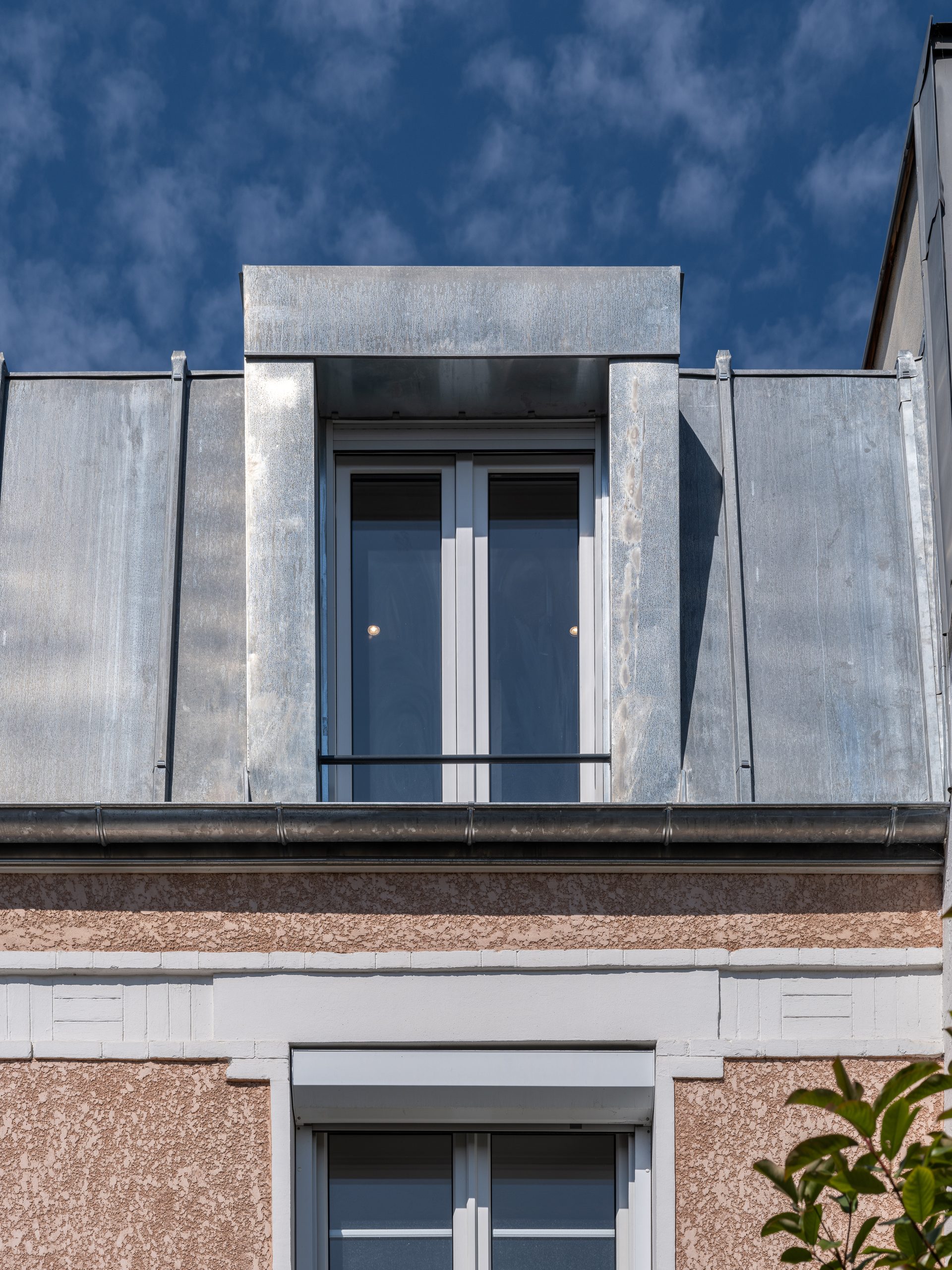 Oïkos Architectes — Surélévation et rénovation d'une maison à Colombes — détail de la surélévation en zinc, lucarne vitrée