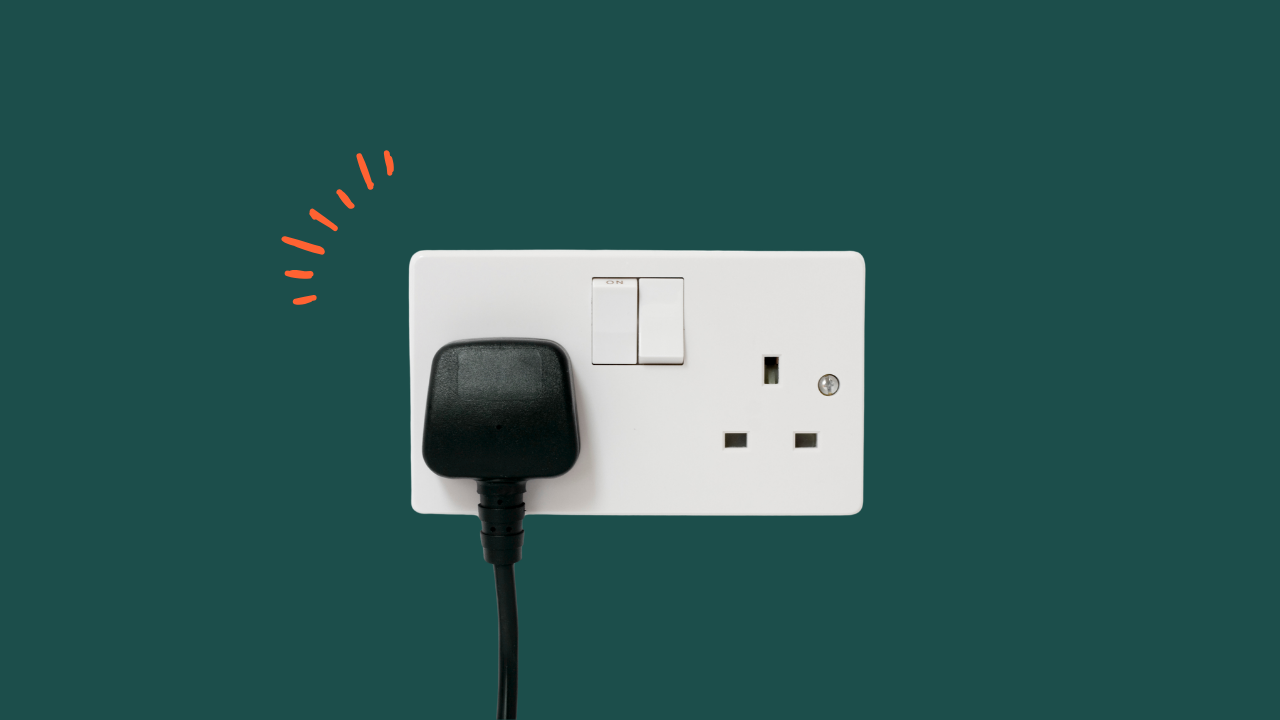 black plug in white socket on green background