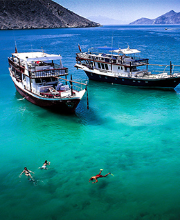 Boats in the lagoon with swimmers