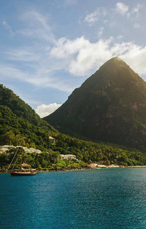 An aerial view of Gros Piton in St Lucia srrounded by the sea.