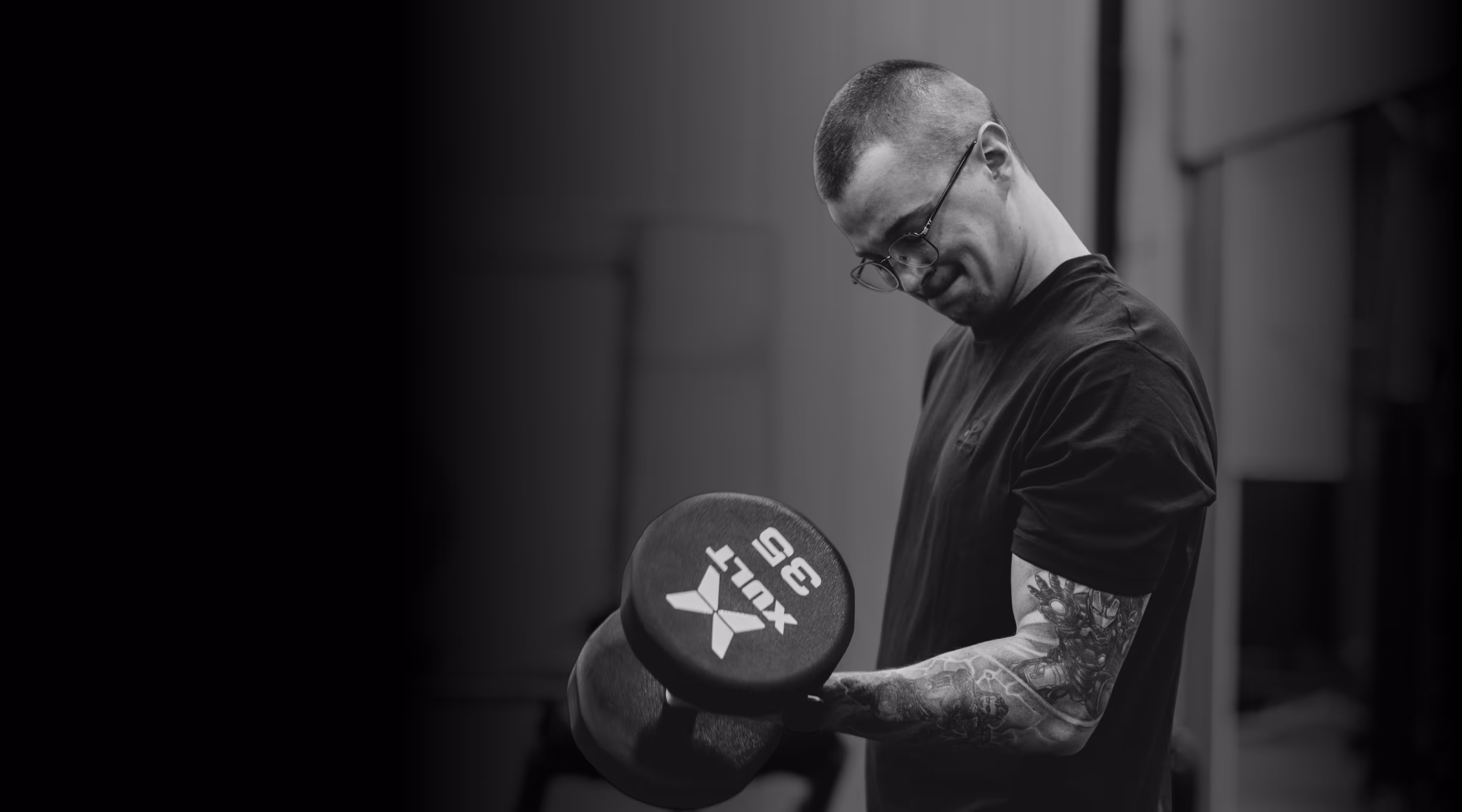 A man holding a black and white frisbee in his right hand.