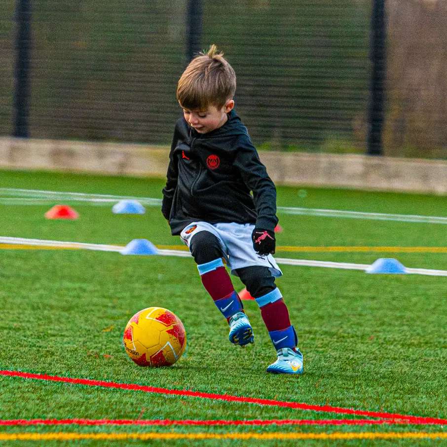 kid playing with a yellow ball