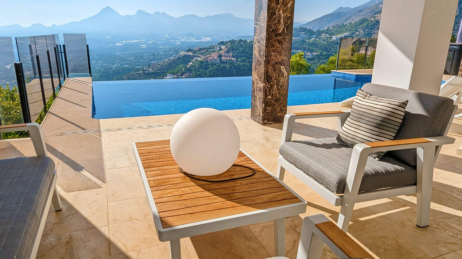 Lounge chairs on terrace with mountains view