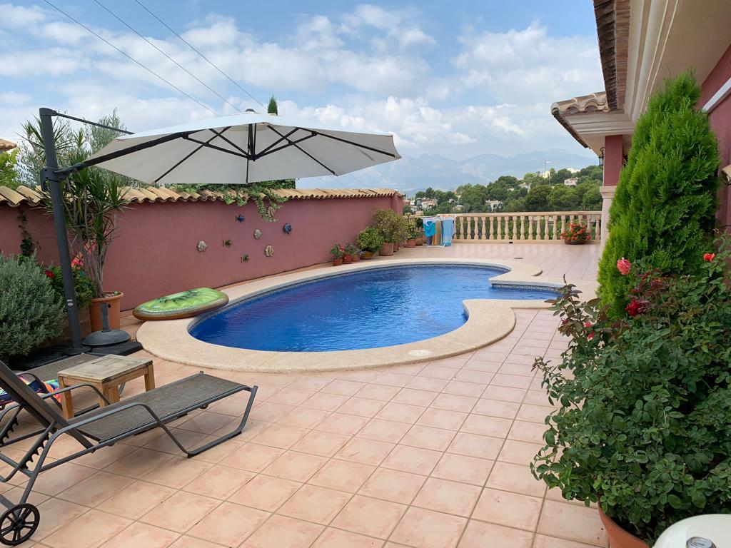 The private kidney-shaped swimming pool and sun terrace at the villa in Altea.