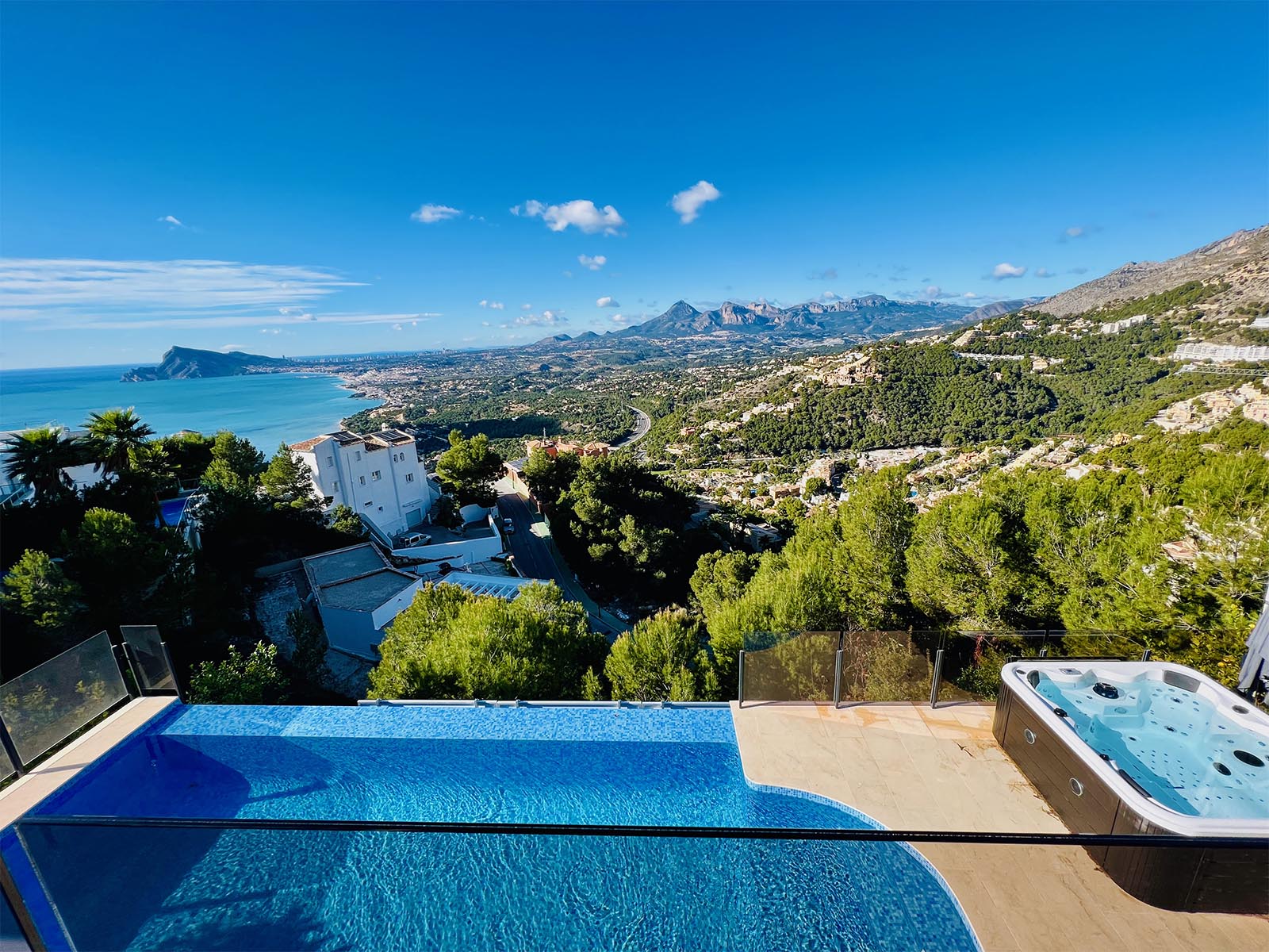 South-facing terrace of Villa AH130 with swimming pool and panoramic Mediterranean view.