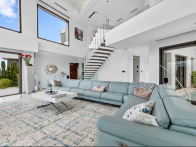 Elegant floating staircase with glass balustrades in modern luxury villa - contemporary architectural design