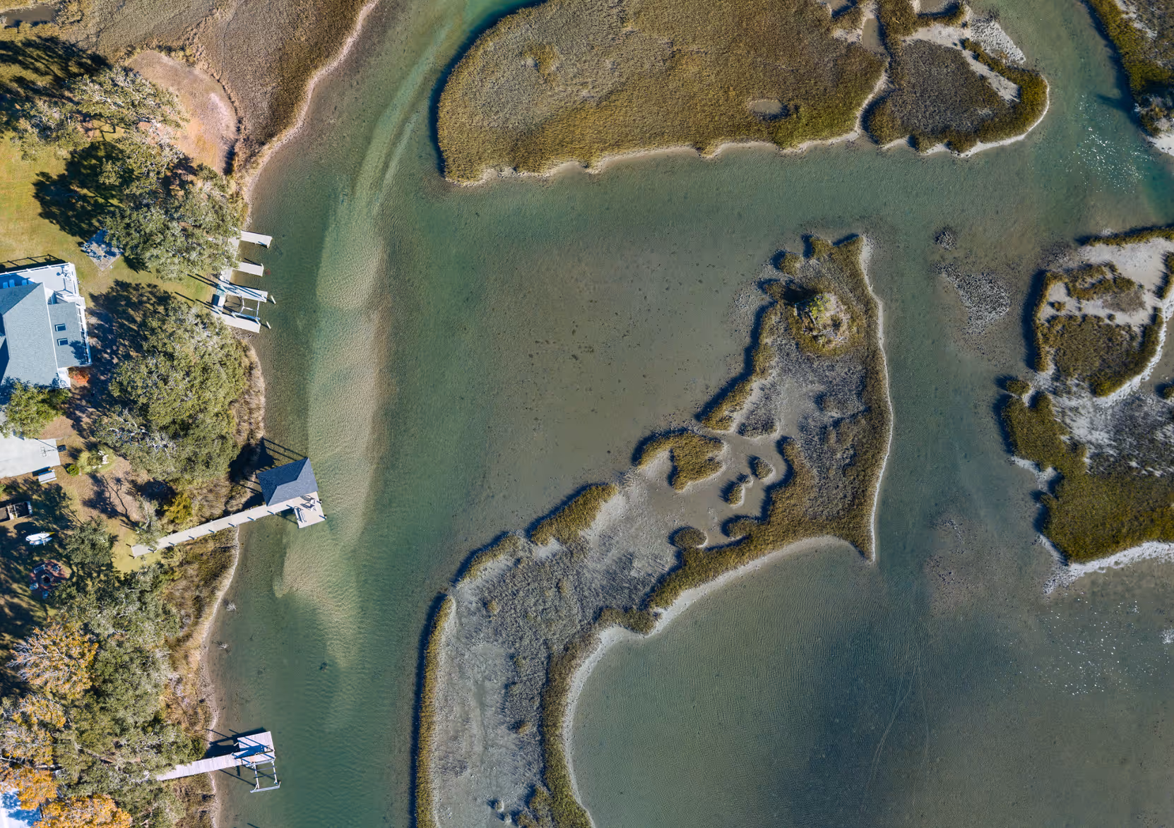 Aerial photo of eastern north carolina coast with marshlands and houses with their private waterfront piers