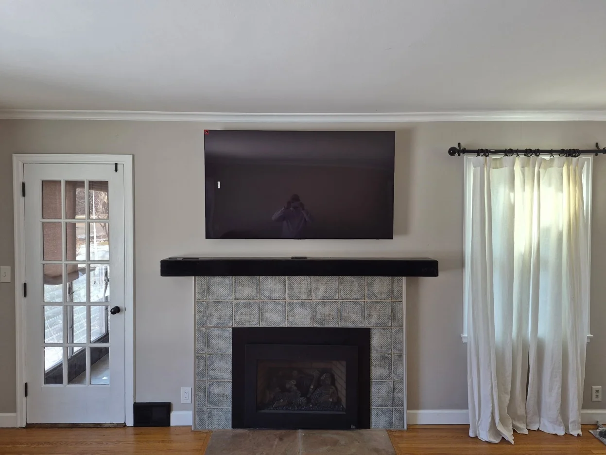 65-inch TV mounted above fireplace with tilt bracket in Minneapolis