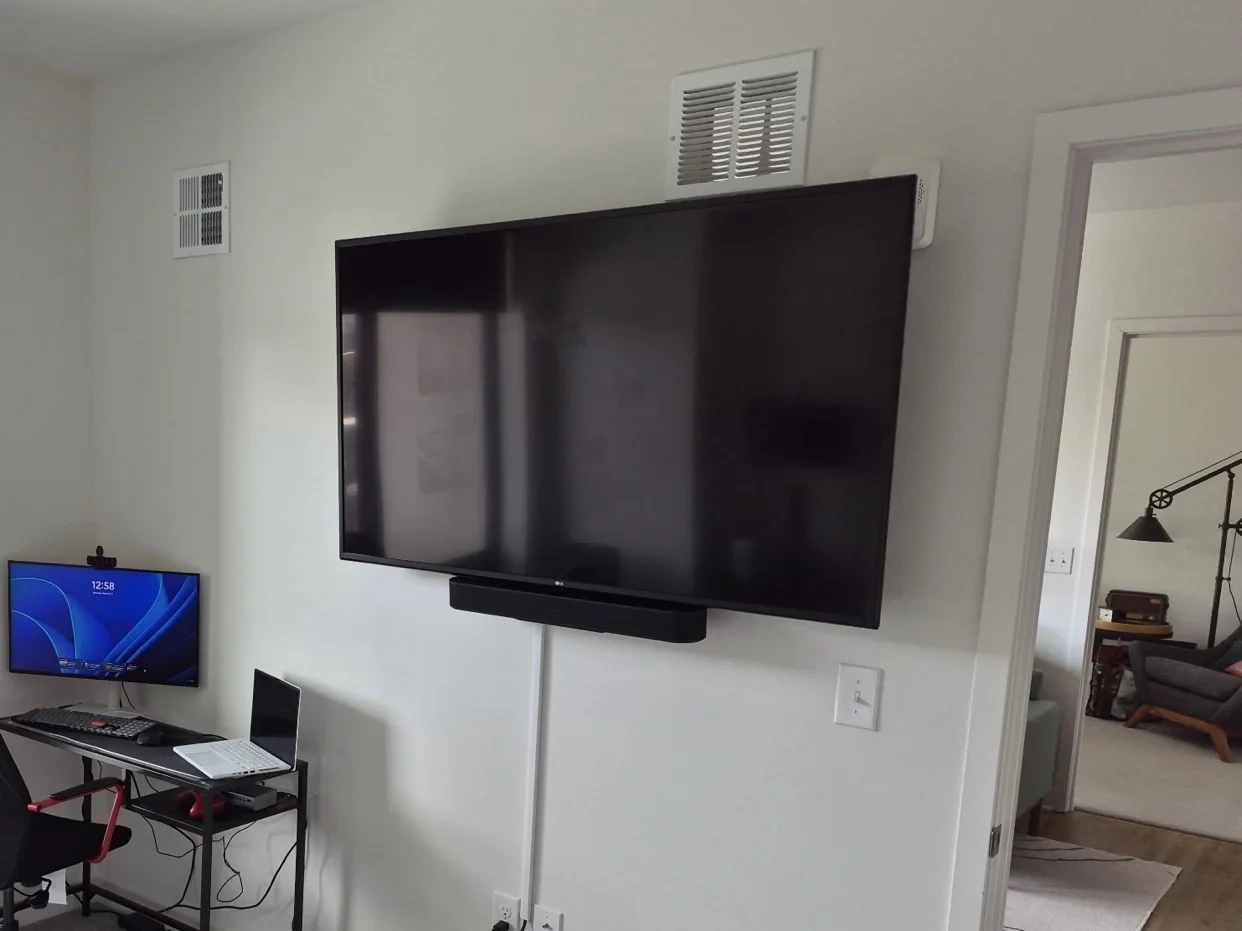 65-inch TV with soundbar mounted on drywall near Lake Calhoun