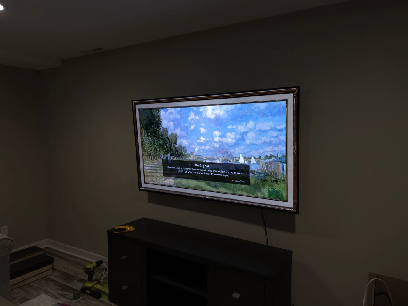 65-inch TV mounted on drywall with tilt bracket in Bloomington media room