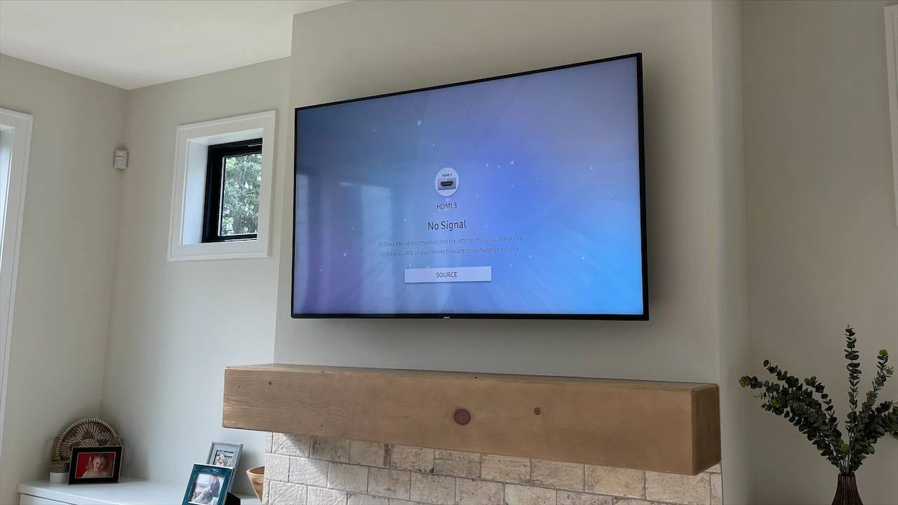 65-inch TV mounted above fireplace in Medina Minnesota with existing conduit cable concealment