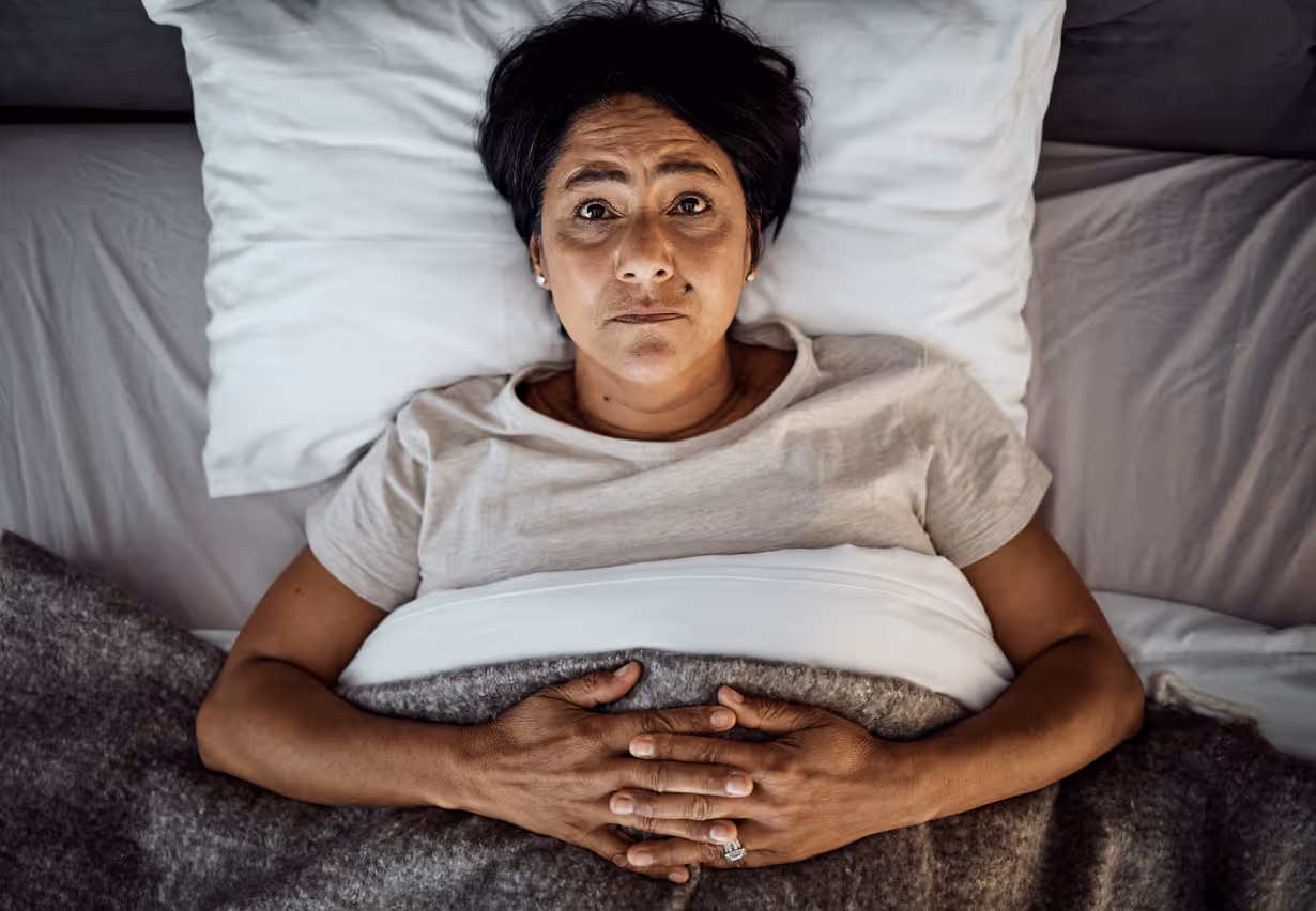 Woman lying awake due to not being able to sleep