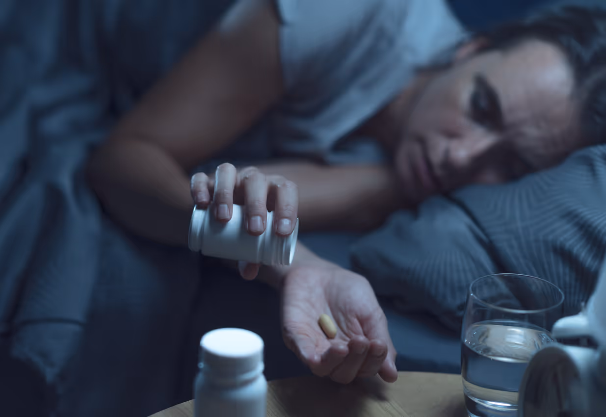 Woman taking pills to sleep