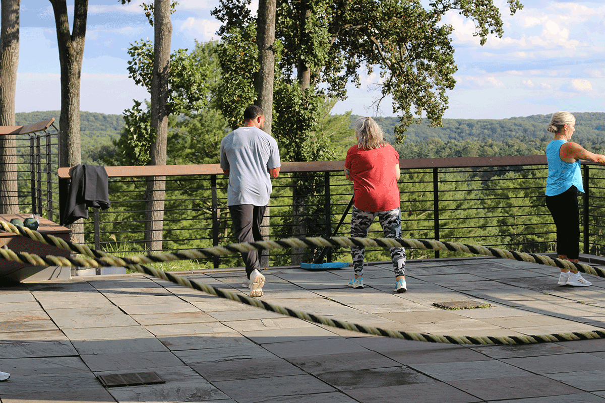 Trainer Nick Rainey instructing a client one-on-one during a group session