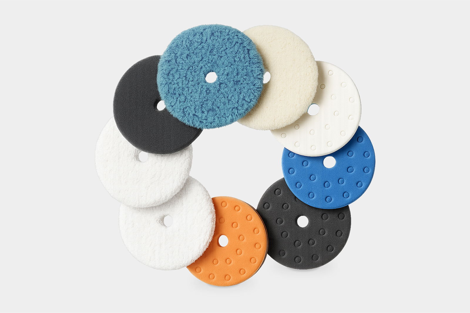 Collection of Lake Country professional polishing pads arranged in a circular layout, showcasing the product range photography created for the rebrand and marketing assets.